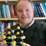 Robert Lad holding a model of molecular structure
