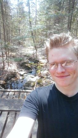 Zachary Smith in front of a stream